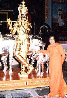 Sai with silver Krishna statue